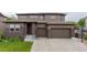 Charming two-story home with brick accents, a two-car garage, and a well-maintained lawn at 11880 W 38Th Pl, Wheat Ridge, CO 80033