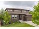 Beautiful two-story home featuring a well-manicured lawn, brick accents, and a two-car garage at 11880 W 38Th Pl, Wheat Ridge, CO 80033