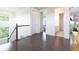 Bright hallway with hardwood floors, white walls, a staircase, and views of adjacent rooms at 11880 W 38Th Pl, Wheat Ridge, CO 80033