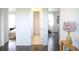 Open hallway with hardwood floors offering views into the bathroom, bedroom, and playroom at 11880 W 38Th Pl, Wheat Ridge, CO 80033