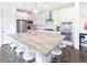 Bright kitchen features stainless steel appliances, pendant lighting, and a large center island with barstool seating at 11880 W 38Th Pl, Wheat Ridge, CO 80033