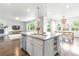 Modern kitchen with center island flowing into the living and dining areas, perfect for entertaining at 11880 W 38Th Pl, Wheat Ridge, CO 80033