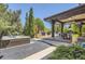 Backyard with hot tub and a cozy covered patio with an outdoor dining area next to the pool at 9470 S Silent Hills Dr, Lone Tree, CO 80124
