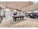 Finished basement with pool table, foosball table, and stone fireplace at 9470 S Silent Hills Dr, Lone Tree, CO 80124