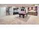 Finished basement features a pool table, kitchenette, and neutral carpeting at 9470 S Silent Hills Dr, Lone Tree, CO 80124