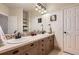 Bathroom featuring double sinks with wood cabinets, large vanity mirror, and tiled backsplash at 9470 S Silent Hills Dr, Lone Tree, CO 80124