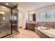 Luxurious bathroom boasts a glass-enclosed shower, soaking tub, and stylish vanity at 9470 S Silent Hills Dr, Lone Tree, CO 80124