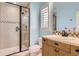 Updated bathroom with a glass shower, vanity with a light wood cabinet, and tiled accents at 9470 S Silent Hills Dr, Lone Tree, CO 80124