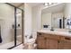 Bathroom with walk-in shower, wood vanity, and tile flooring at 9470 S Silent Hills Dr, Lone Tree, CO 80124