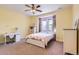 Cozy bedroom with a butterfly themed comforter, natural light, and a ceiling fan at 9470 S Silent Hills Dr, Lone Tree, CO 80124