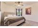 Comfortable bedroom with large bed, plush carpet, and a bright window seat at 9470 S Silent Hills Dr, Lone Tree, CO 80124