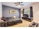 Cozy bedroom features a modern ceiling fan, carpet and a large window at 9470 S Silent Hills Dr, Lone Tree, CO 80124