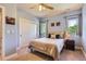 Blue bedroom featuring white closet doors, natural light, and a ceiling fan at 9470 S Silent Hills Dr, Lone Tree, CO 80124