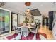 A formal dining room with views of kitchen and an exquisite light fixture at 9470 S Silent Hills Dr, Lone Tree, CO 80124