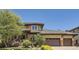 Charming two-story home with three-car garage and beautiful landscaping, featuring a cozy front porch at 9470 S Silent Hills Dr, Lone Tree, CO 80124