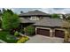 Elegant two-story home with a well-manicured front yard and a three-car garage in a beautiful neighborhood at 9470 S Silent Hills Dr, Lone Tree, CO 80124