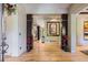 Inviting foyer features gleaming hardwood floors and decorative columns with artistic accents at 9470 S Silent Hills Dr, Lone Tree, CO 80124