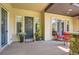 Inviting front porch with seating, decorative flower pots, and a welcoming wreath on the front door at 9470 S Silent Hills Dr, Lone Tree, CO 80124