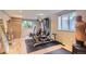 Home gym with modern equipment, mirror, and bright windows at 9470 S Silent Hills Dr, Lone Tree, CO 80124
