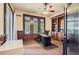 Spacious home office with custom built-ins, paneled walls and large windows at 9470 S Silent Hills Dr, Lone Tree, CO 80124