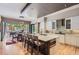 Modern kitchen with a breakfast bar, designer pendant lights, and an open layout to the dining area at 9470 S Silent Hills Dr, Lone Tree, CO 80124