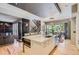 Modern kitchen featuring a large island with stainless steel appliances and dining area nearby at 9470 S Silent Hills Dr, Lone Tree, CO 80124