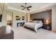 Serene main bedroom with elegant tray ceiling, large bed, sitting area, and ensuite bath at 9470 S Silent Hills Dr, Lone Tree, CO 80124