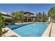 Resort-style backyard with a sparkling pool, comfortable lounge chairs, and lush greenery for privacy at 9470 S Silent Hills Dr, Lone Tree, CO 80124