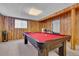 Basement with a recreational area including a wooden paneled wall and a pool table with red felt at 16941 E Eastman Pl, Aurora, CO 80013