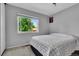 Bedroom with a large window, a black and white quilt on the bed and neutral walls at 16941 E Eastman Pl, Aurora, CO 80013