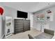 Bright bedroom with carpet, natural light from two windows, modern mirror, and dresser at 16941 E Eastman Pl, Aurora, CO 80013