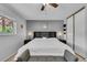 Bedroom featuring a ceiling fan, neutral walls, closet, and headboard with built-in shelves at 16941 E Eastman Pl, Aurora, CO 80013