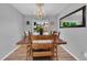 Bright dining room features a chandelier, large window, and a spacious wooden dining table at 16941 E Eastman Pl, Aurora, CO 80013