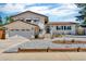 Charming home boasts manicured landscaping, a two-car garage, and brick accents at 16941 E Eastman Pl, Aurora, CO 80013
