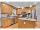 Bright kitchen features stainless steel appliances, light wood cabinets, and a functional center island at 16941 E Eastman Pl, Aurora, CO 80013