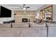 Cozy living room with a brick fireplace, white mantel, ceiling fan, and a large sectional sofa at 16941 E Eastman Pl, Aurora, CO 80013