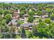 This aerial view showcases a well-maintained home surrounded by mature trees in a suburban neighborhood at 11035 W 26Th Pl, Lakewood, CO 80215