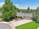 Aerial view of a charming residence with a well-manicured lawn, mature trees, and a spacious driveway at 11035 W 26Th Pl, Lakewood, CO 80215