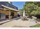 Outdoor patio area and hot tub in a landscaped backyard with mature trees at 11035 W 26Th Pl, Lakewood, CO 80215