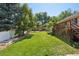 Spacious backyard with mature trees, a deck, and a shed offers a great outdoor living space at 11035 W 26Th Pl, Lakewood, CO 80215
