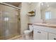 Bathroom featuring a tiled shower with a glass door, modern fixtures and vanity at 11035 W 26Th Pl, Lakewood, CO 80215