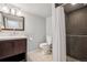 Clean bathroom with a tiled shower, modern vanity, and neutral color palette at 11035 W 26Th Pl, Lakewood, CO 80215