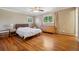 Bright bedroom features hardwood floors, ceiling fan, and a window with natural light at 11035 W 26Th Pl, Lakewood, CO 80215