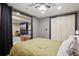 Bedroom leading to basement living area with ceiling fan and closet at 11035 W 26Th Pl, Lakewood, CO 80215