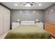 Bedroom with double bed, white nightstands, closet and paneled closet door at 11035 W 26Th Pl, Lakewood, CO 80215