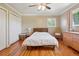 Cozy bedroom features hardwood floors, ceiling fan, and ample closet space at 11035 W 26Th Pl, Lakewood, CO 80215