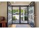 View of the home's entry and neighborhood from the open double front doors at 11035 W 26Th Pl, Lakewood, CO 80215