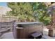 Outdoor hot tub with cover, steps, and wood surround and fenced yard at 11035 W 26Th Pl, Lakewood, CO 80215