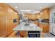 Open kitchen featuring a large island, stainless steel appliances, light wood cabinets, and hardwood floors at 11035 W 26Th Pl, Lakewood, CO 80215