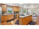 Bright kitchen showcases an island with seating, stainless steel appliances, and plentiful cabinet space at 11035 W 26Th Pl, Lakewood, CO 80215